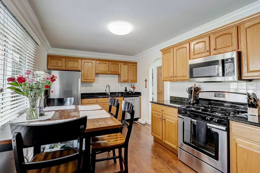 Kitchen with gas range and vase of flowers